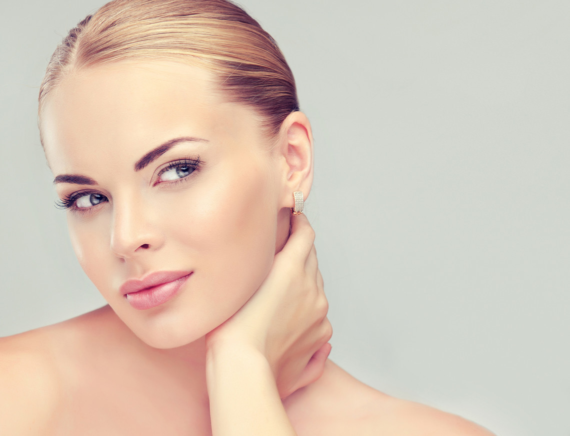 Beautiful Young Woman with Clean Fresh Skin close up . Skin care face . Cosmetology